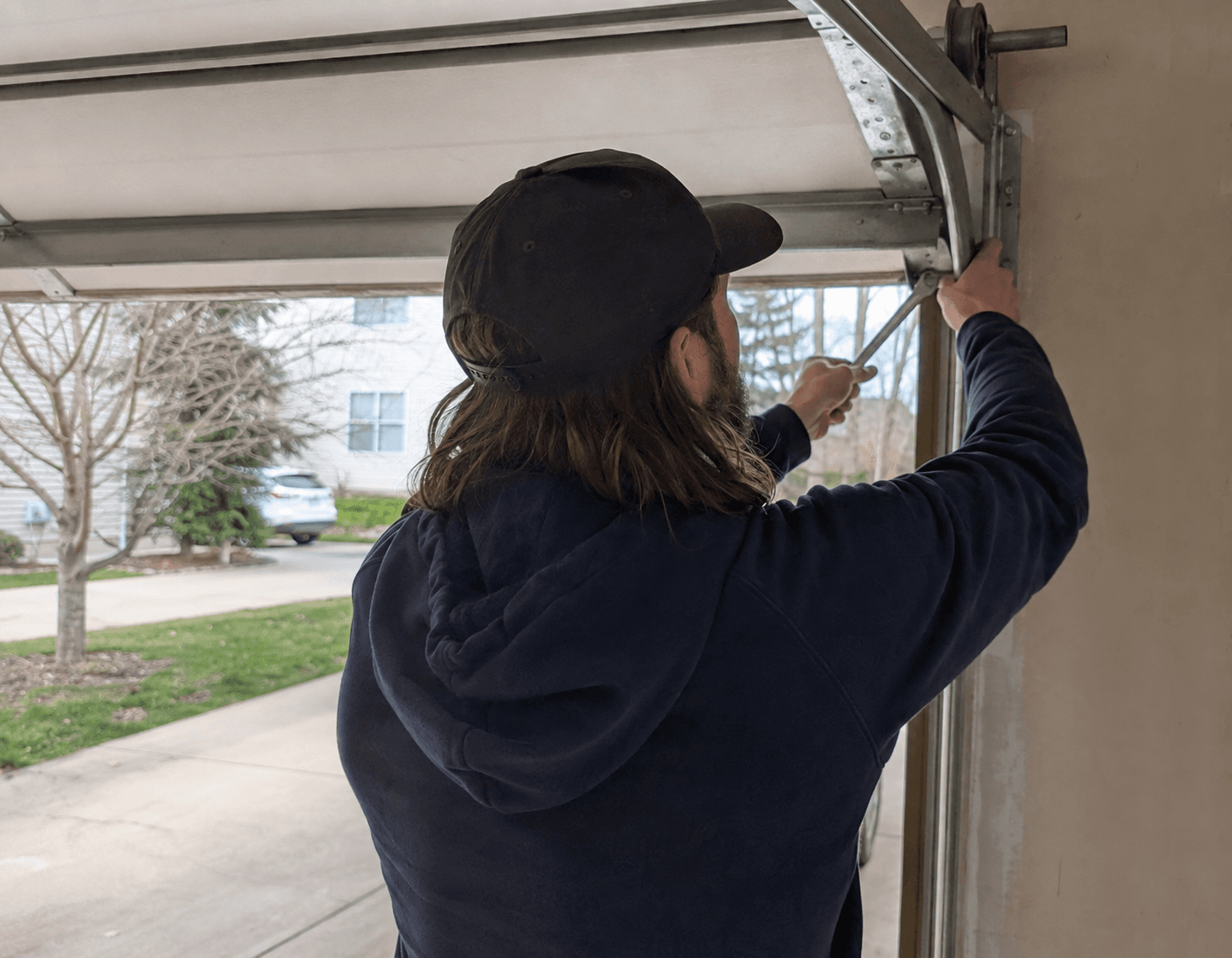 Service tech working on a garage door.