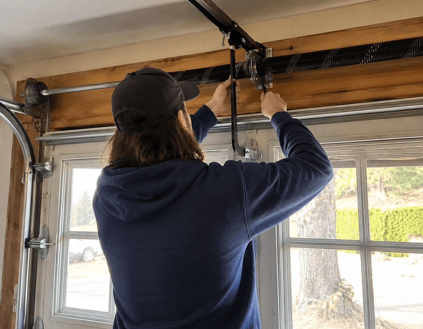 Service tech working on a garage door.